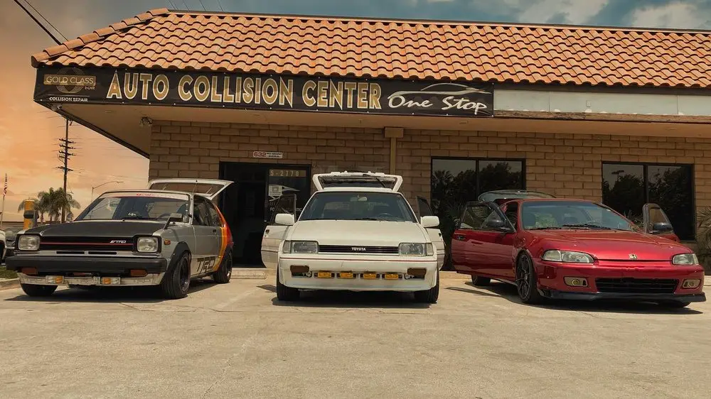Classic Toyota hatchbacks and a red Honda Civic outside One Stop Auto Collision Center, Covina